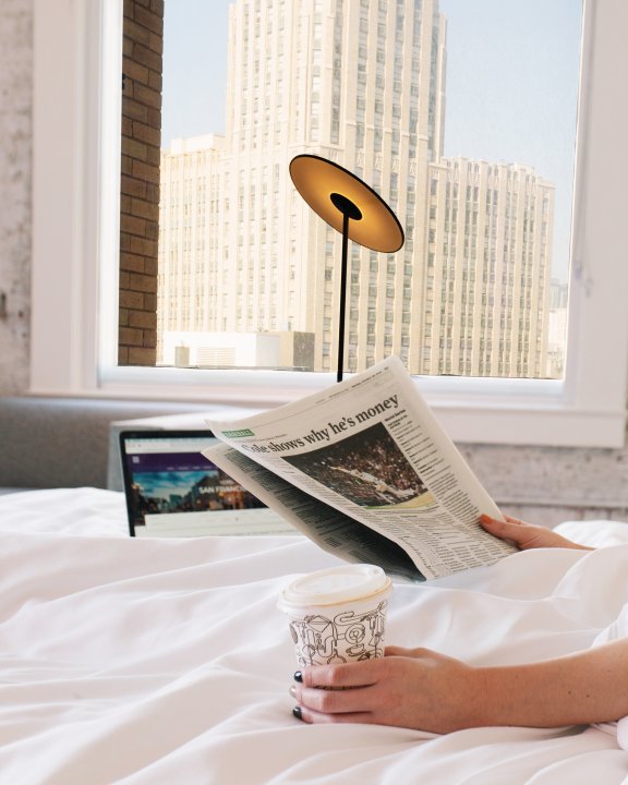 Woman in bed drinking coffee